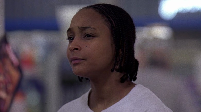 Snoop (Felicia Pearson) standing and knitting her brows on The Wire S4E1