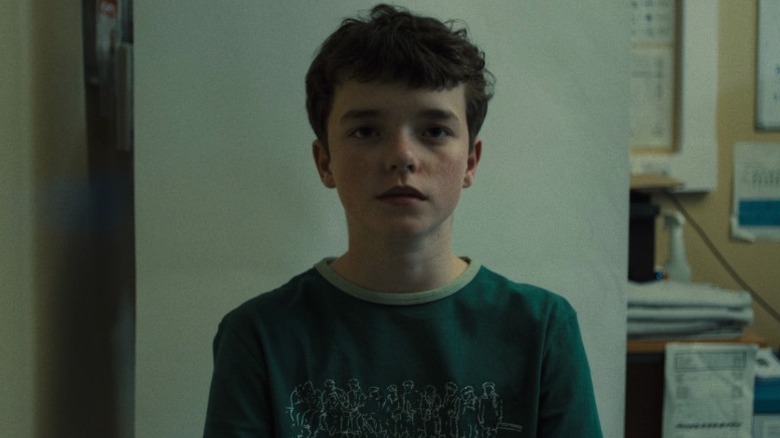 Jamie (Owen Cooper) getting his picture taken on Adolescence S1E1
