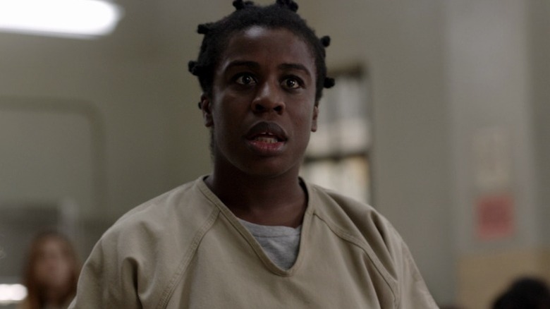 Suzanne (Uzo Aduba) standing and staring intently on Orange Is the New Black S1E3