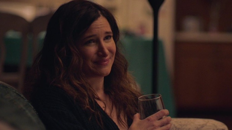 Kathryn Hahn smiling with a glass of wine as Eve in Mrs. Fletcher