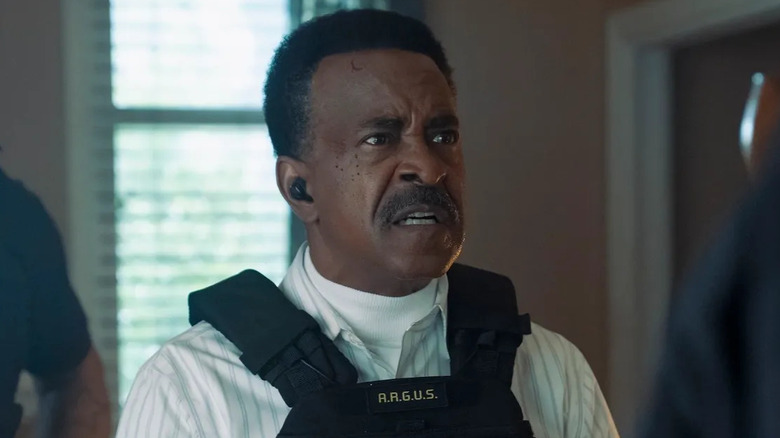 Tim Meadows as Langston looking angry in a SWAT jacket in Peacemaker