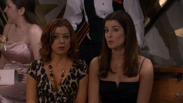 Lily sitting in a dress next to Robin, speaking