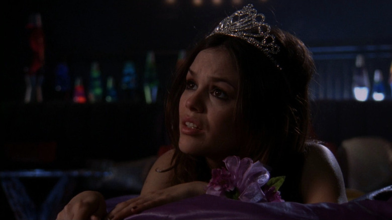 Summer wearing prom queen crown and corsage, looking upset