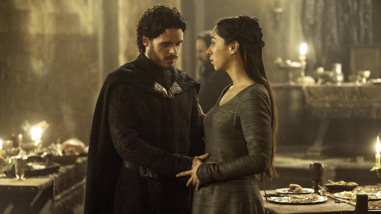 Rob Stark, touching the stomach of Talisa Stark in Game of Thrones.