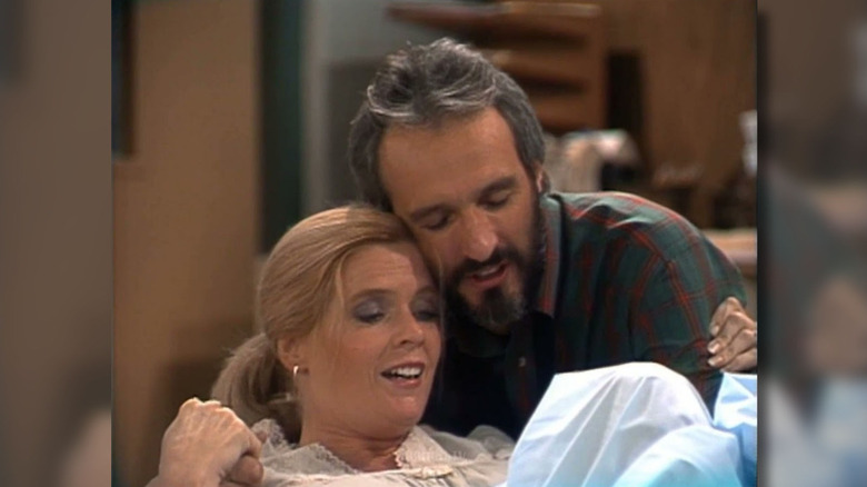 Meredith Baxter as Elyse being held by Michael Gross as Steven in Family Ties