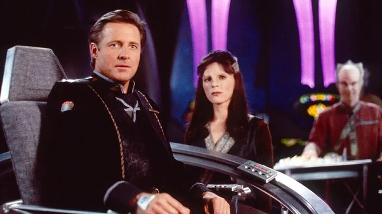 Bruce Boxleitner as John Sheridan sitting in captain's chair with Mira Furlan as Delenn next to him in Babylon 5