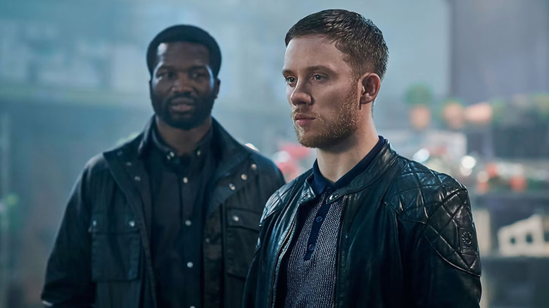Joe Cole as Sean Wallace and Sope Dirisu as Elliot Finch, standing together in Gangs of London.