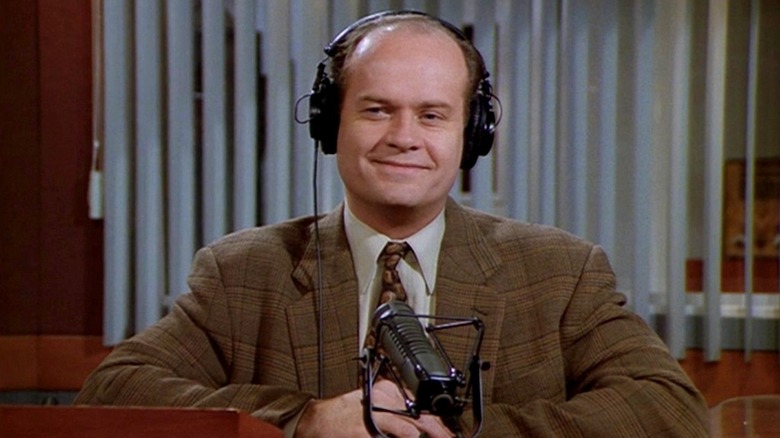 Frasier Crane talks into a microphone in Frasier