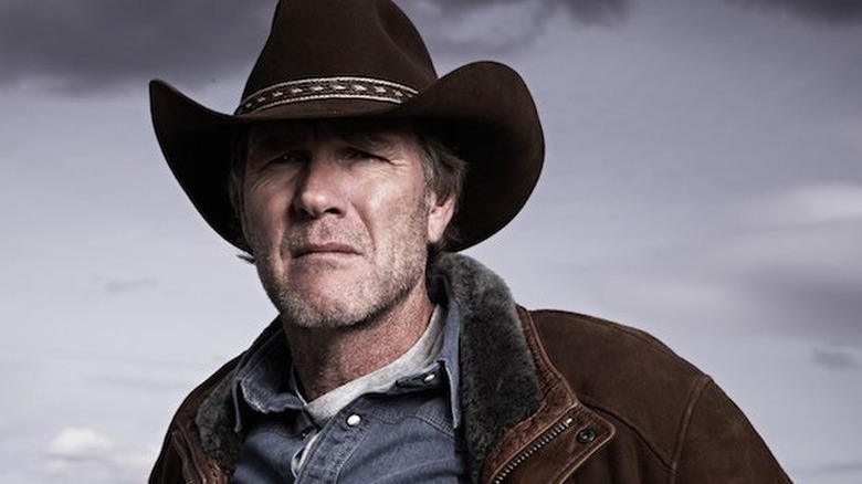 Robert Taylor as Walt Longmire with cowboy hat in front of grey background in Longmire