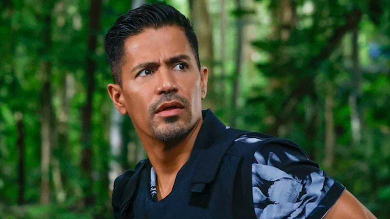 Jay Hernandez as Thomas Magnum in jungle wearing bulletproof vest in Magnum P.I.