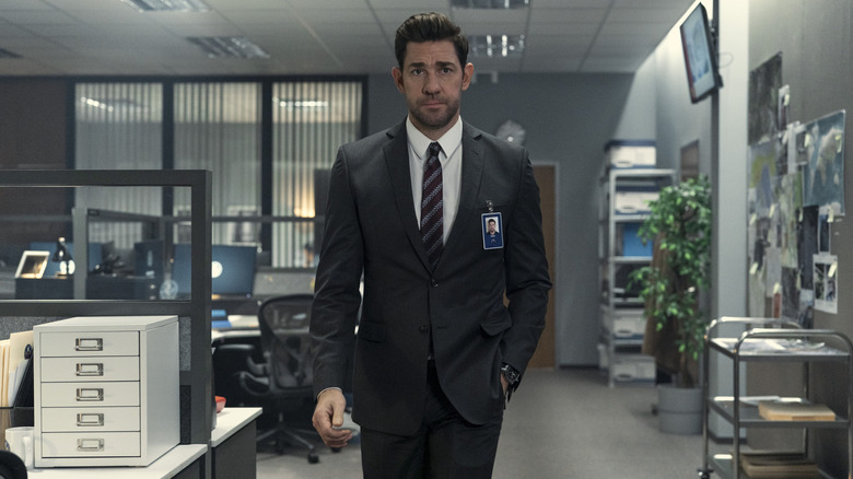 John Krasinski as Jack Ryan in suit walking through office in Tom Clancy's Jack Ryan