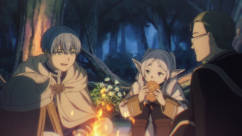 Himmel, Frieren, and Heiter sit around a fire eating in Frieren: Beyond Journey's End.