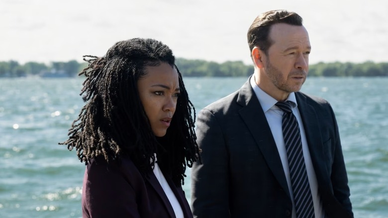 Lena Silver (Sonequa Martin-Green) and Danny Reagan (Donnie Wahlberg) stand by the ocean in Boston Blue