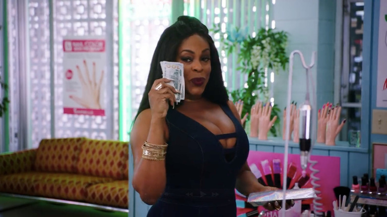 Desna Simms (Nicey Nash) flashes some cash in Claws