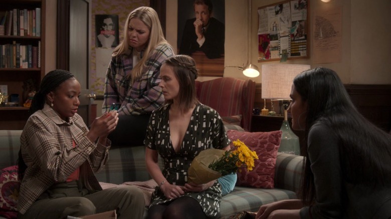 Whitney looking worriedly at her phone while Leighton, Kimberly, and Bela look on and frown on The Sex Lives of College Girls S2E2