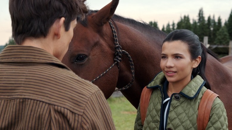 Nikki Rodriguez as Jackie standing next to brown horse in My Life With the Walter Boys