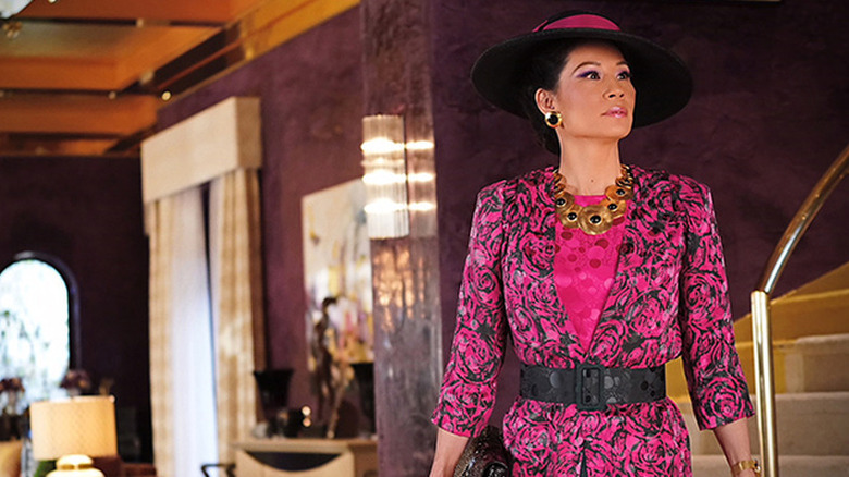 Lucy Liu as Simone in bright pink top and hat in Why Women Kill