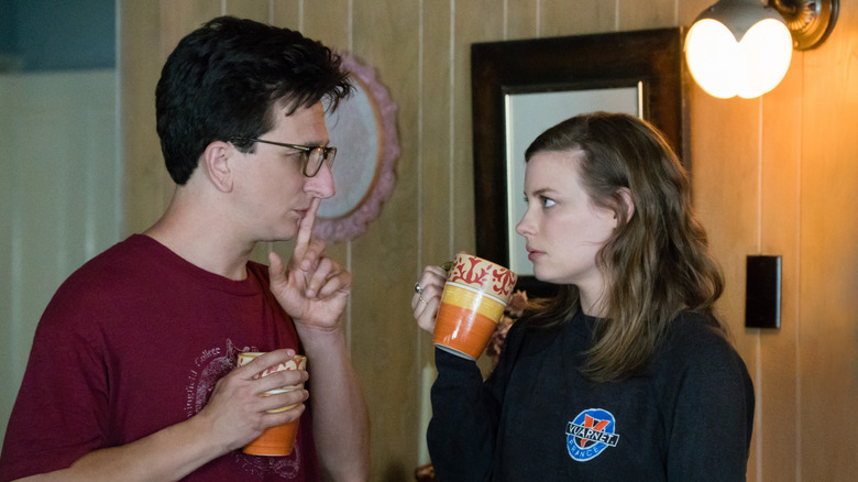 Gus putting his finger to his mouth to shush in Love
