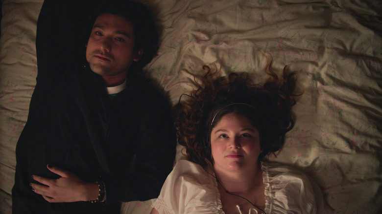 couple lying on a bed in Too Much