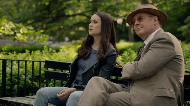 Megan Boone as Elizabeth Keen sitting on bench next to James Spader as Raymond Reddington in The Blacklist