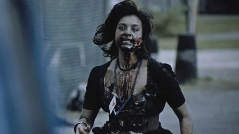 A female zombie walking the streets on "Dead Set."