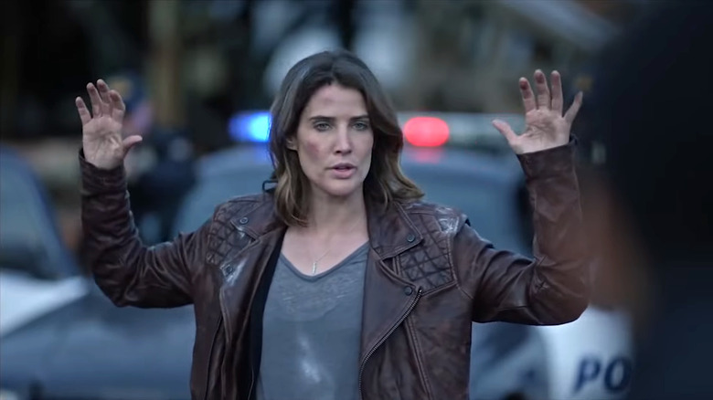 Cobie Smulders' Dex Parios raising her hands in Stumptown