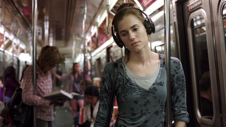 Marnie wearing headphones on the subway in Girls