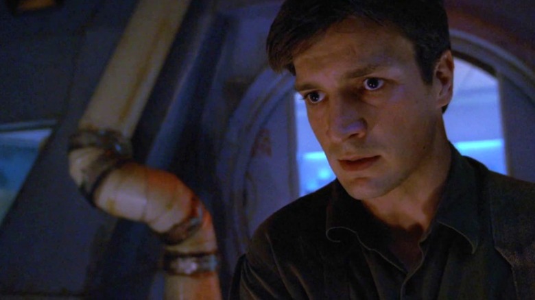 Mal standing with a worried expression on Firefly S1E7