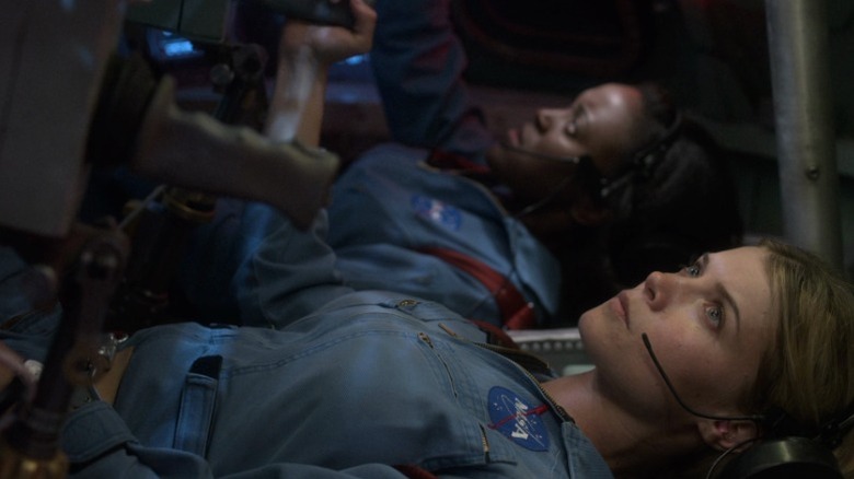 Danielle and Tracy sitting horizontally in a space shuttle on For All Mankind S1E3