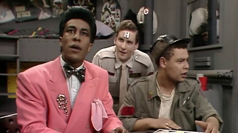 Rimmer standing behind the Cat and Lister on Red Dwarf S1E1
