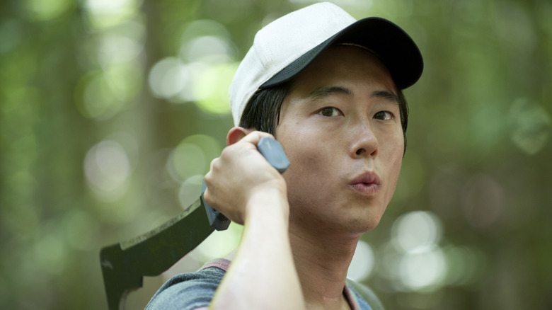 Glenn (Steven Yeun) wields a machete in The Walking Dead