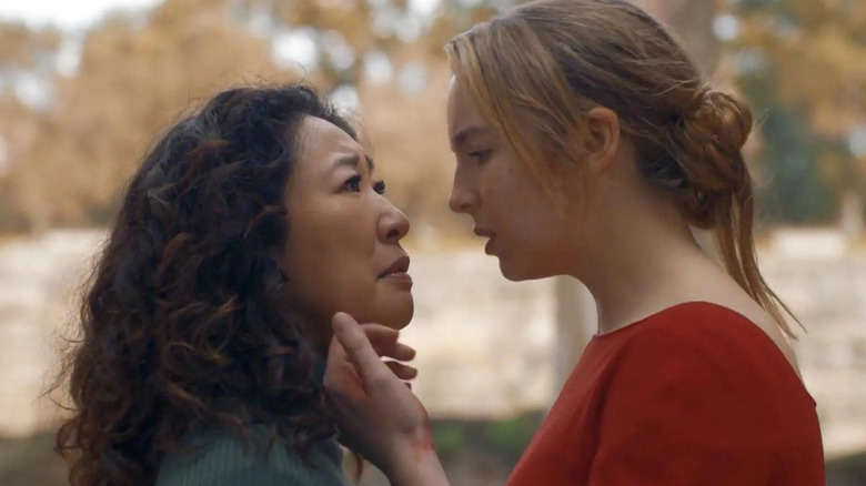 Eve (Sandra Oh) is caressed by Villanelle (Jodie Comer) in Killing Eve