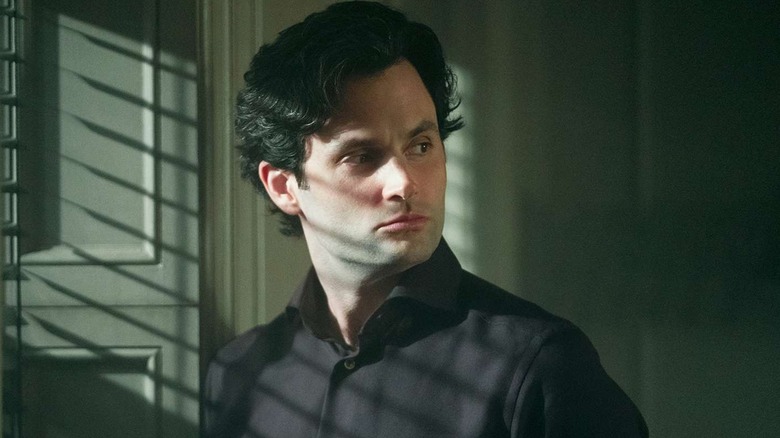 Penn Badgley as Joe Goldberg, looking over his shoulder in You.