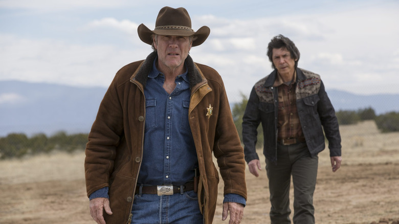 Robert Taylor as Walt Longmire walks ahead of Lou Diamond Phillips as Henry Standing Bear in Longmire