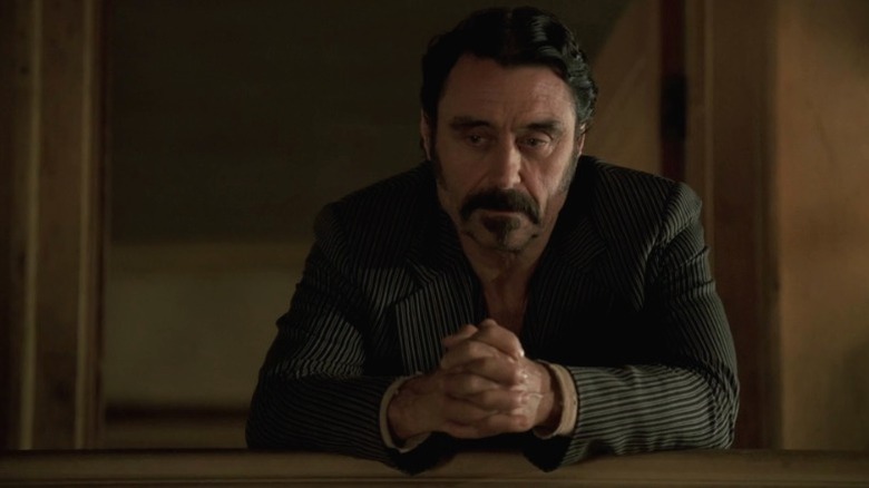 Al standing on the balcony and looking down on Deadwood S1E12