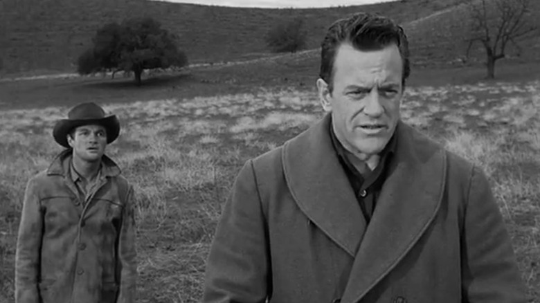 Pruitt standing behind Matt in a field on Gunsmoke S7E22
