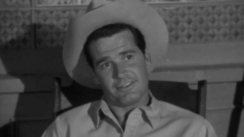 Bret sitting on a rocking chair and smirking on Maverick S2E10