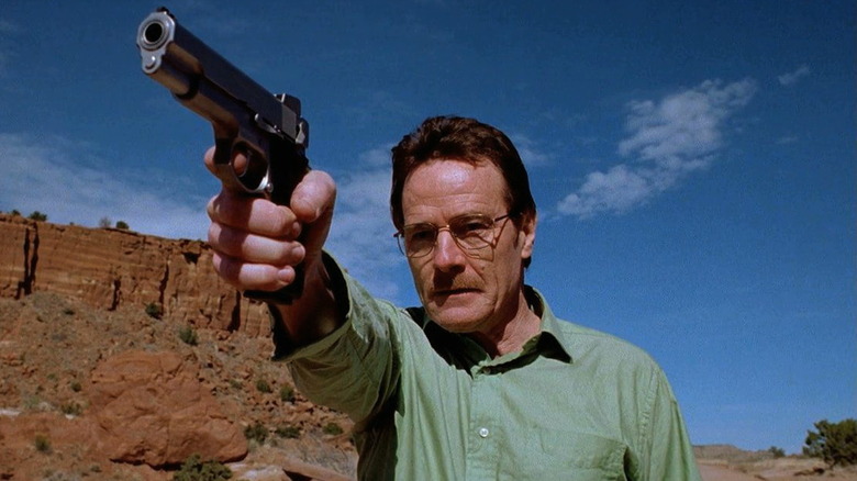 Bryan Cranston as Walter White, aiming a pistol in Breaking Bad.