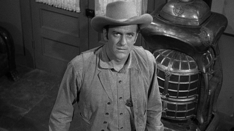 James Arness as Matt Dillon, looking up in anger in Gunsmoke.