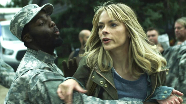 Rose (Jaime King) tries to get past a soldier restraining her in Black Summer