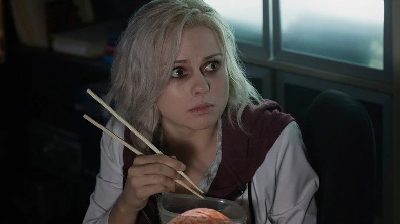 Liv Moore (Rose McIver) looks up while holding chopsticks over brains in iZombie
