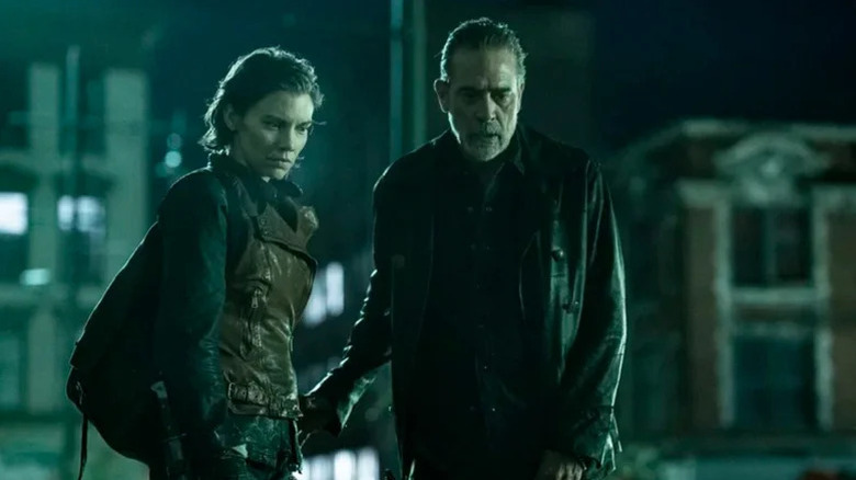 Maggie Rhee (Lauren Cohan) and Negan (Jeffrey Dean Morgan) look down inquisitively in The Walking Dead: Dead City