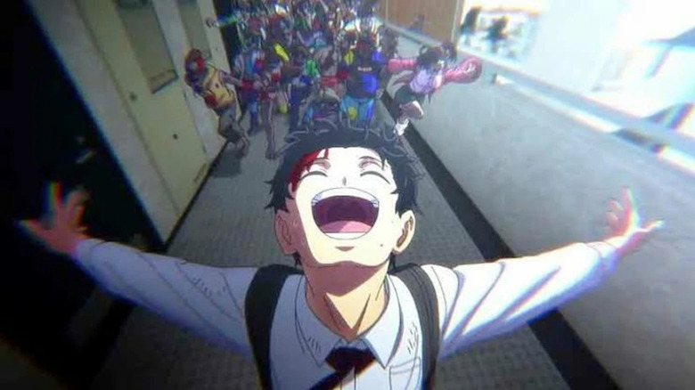 Akira Tendo shouts jubilantly with his arms outstretched as zombies charge behind in Zom 100: Bucket List of the Dead