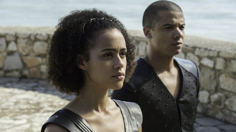 Nathalie Emmanuel as Missandei standing with Jacob Anderson as Grey Worm in Game of Thrones
