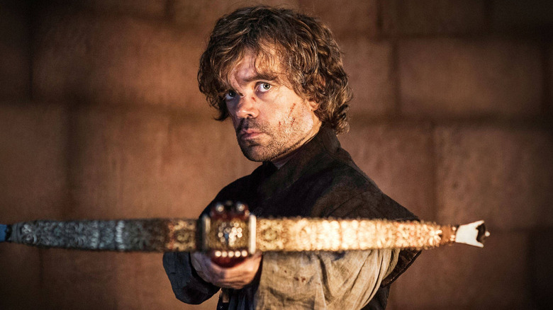 Peter Dinklage as Tyrion holding a crossbow in Game of Thrones