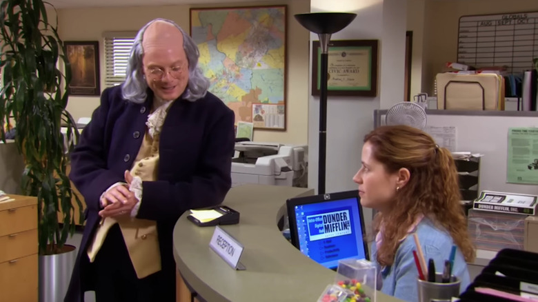 Andy Daly as Ben Franklin talks to Jenna Fischer as Pam Beesly on The Office