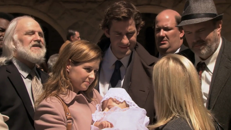 Jenna Fischer as Pam Beesly stands next to John Krasinski as Jim Halpert on The Office