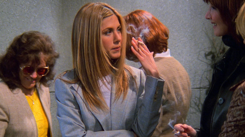 Jennifer Aniston as Rachel Green pretending to smoke a cigarette next to her boss, Joanna Gleason as Kim Clozzi in Friends  as