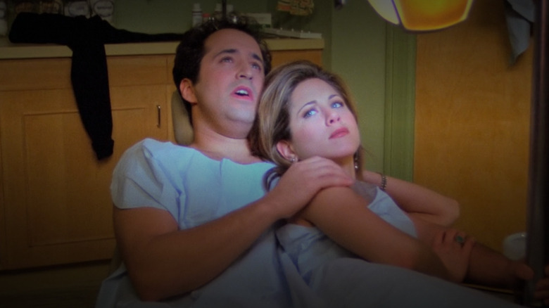 Mitchell Whitfield as Barry cuddling with Jennifer Aniston as Rachel Green in his orthodontist chair after they hook up in Friends