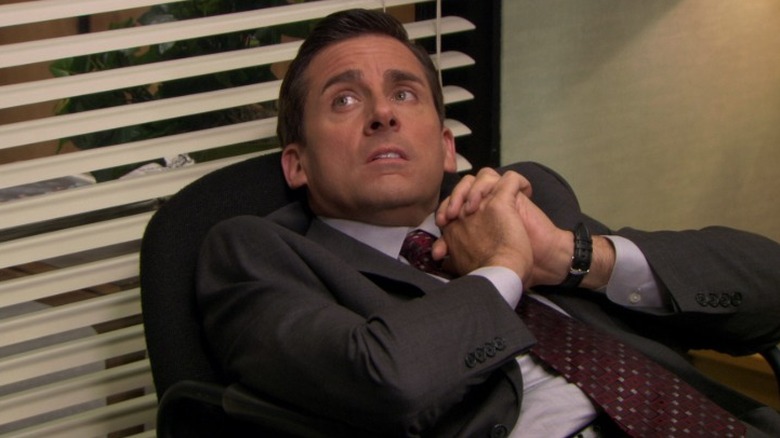 Michael sitting in a chair on The Office S6E12